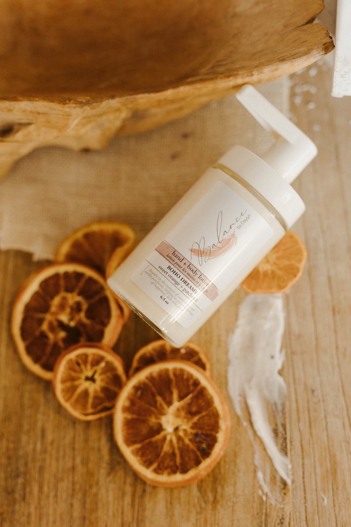 bottle of all natural body lotion with sweet orange and patchouli essence by balance by daylyn