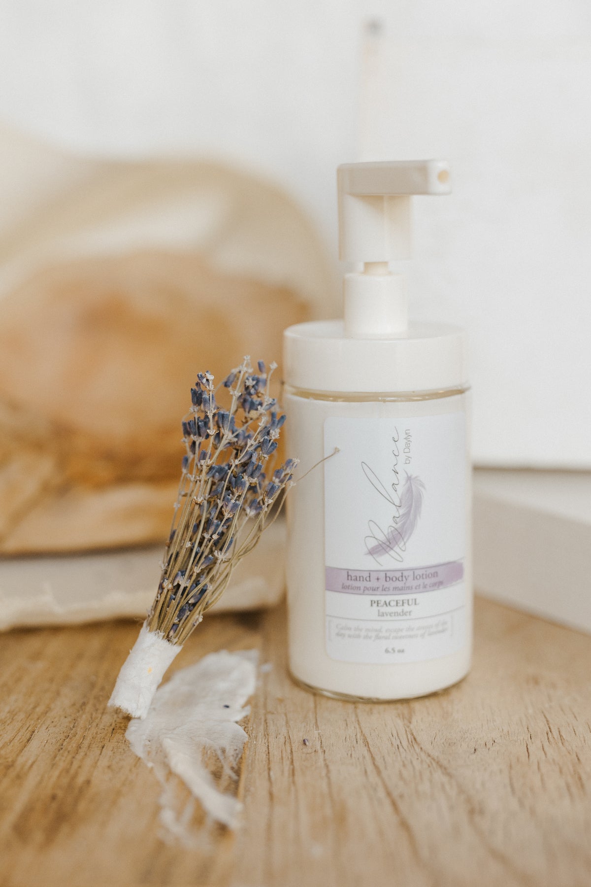 bottle of peaceful lavender hand and body lotion by balance by daylyn with almond oil, shea butter, and more natural ingredients